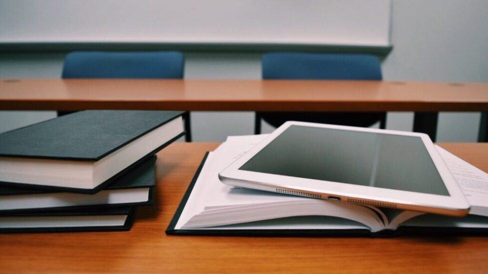silver ipad on white book page